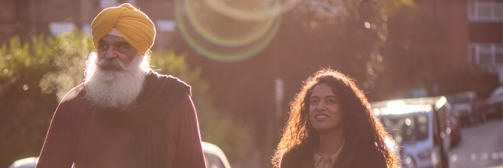 A man and lady walking in the sunshine