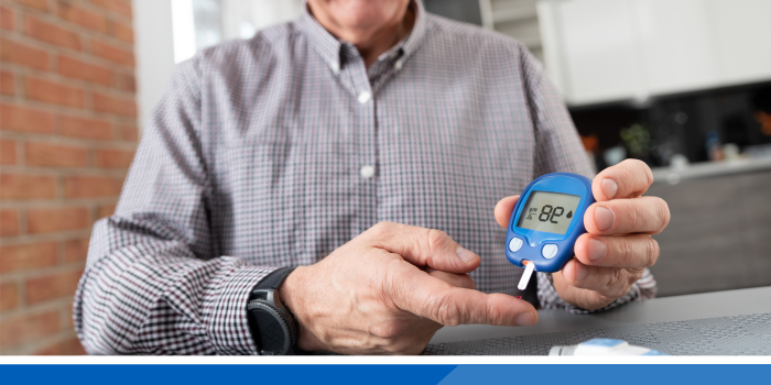 Man checking his blood sugar levels using a finger prick test
