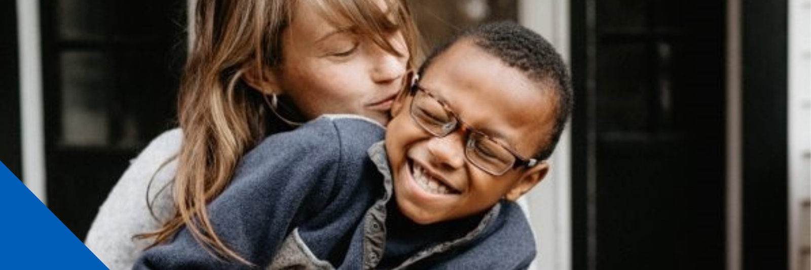 Woman and child cuddling and smiling