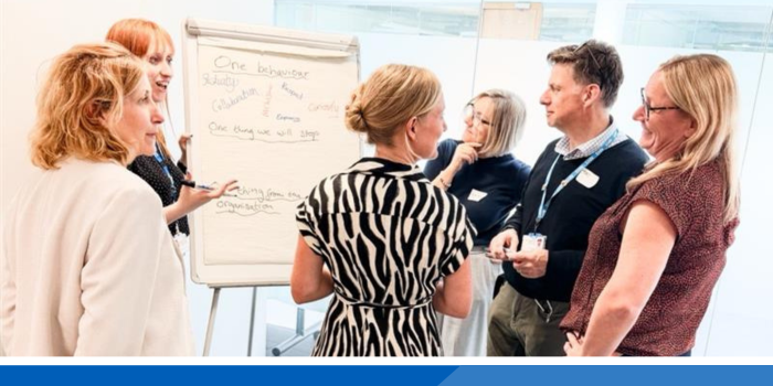 Group of Central East ICB staff having a planning discussion around a flip chart