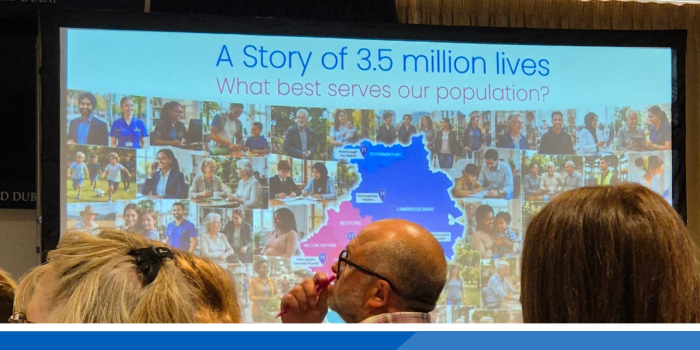 An image of a presentation screen at a staff event which says 'A story of 3.5 million lives. What best serves our population?'