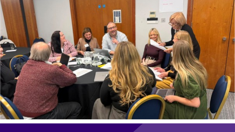 Delegates engaging in collaborative table discussions during the East of England Work & Health Network event in Cambridge.